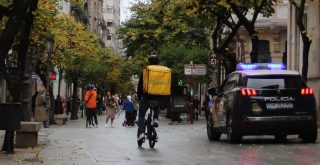 Policía y repartidor de Glovo en el Paseo